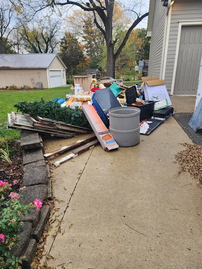 Dumpster being loaded with debris for Estate Cleanout Dumpster Rental in McFarland